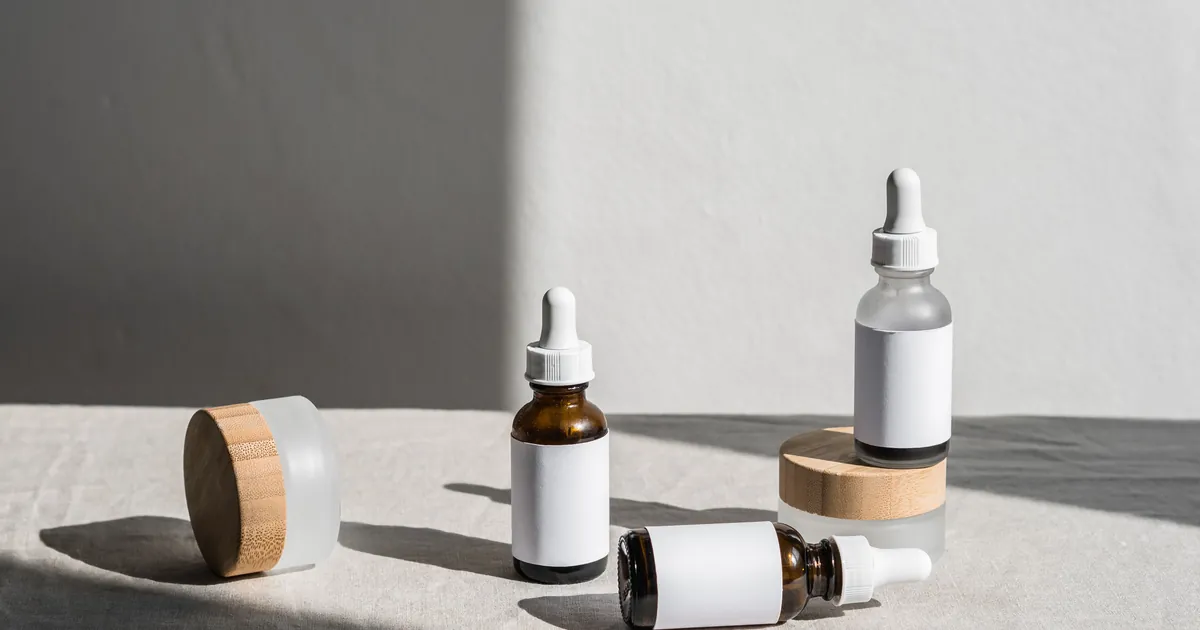 Three amber bottles on a sunlit shelf, the kind of half-used repellent that sits in a cabinet for years