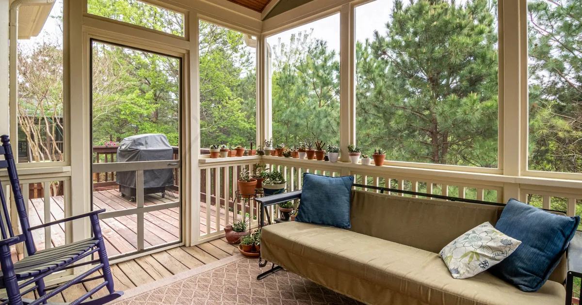 A screened porch opening onto greenery, the mesh line of defense no-see-ums slip through