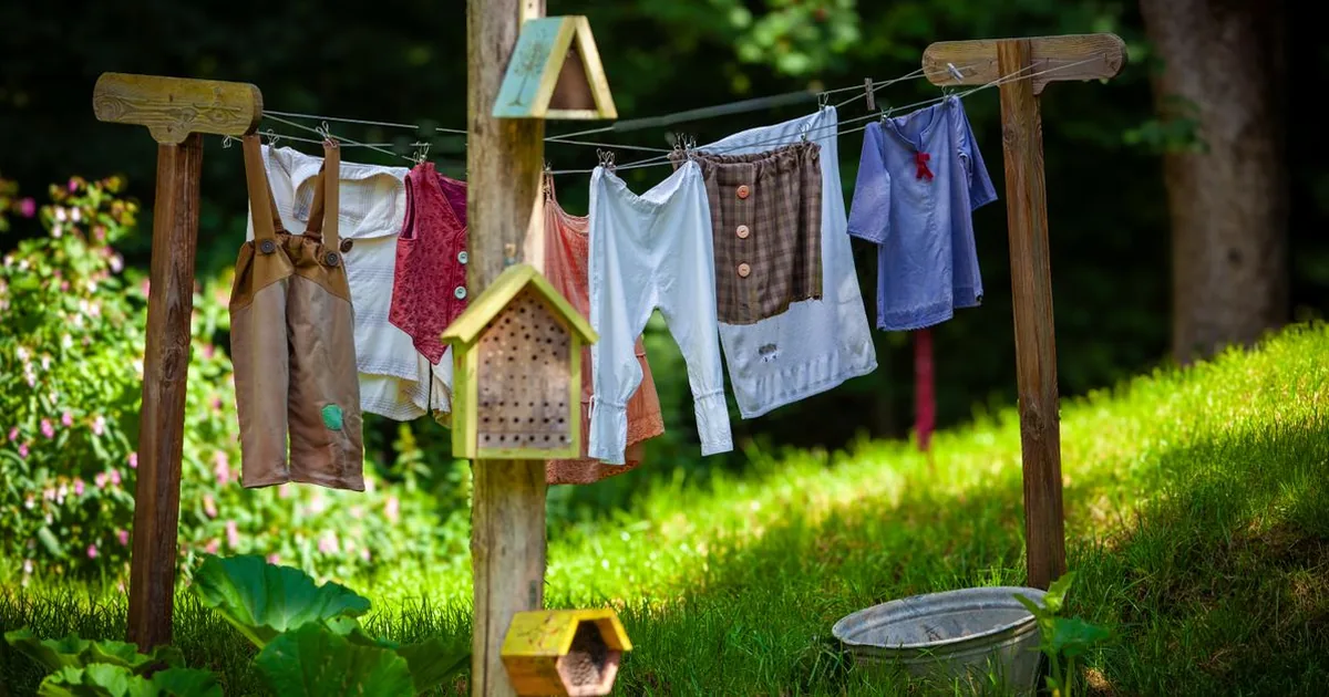 Hiking shirt, pants, socks, and boots laid out flat before treating the clothing layer of a two-layer insect protection system