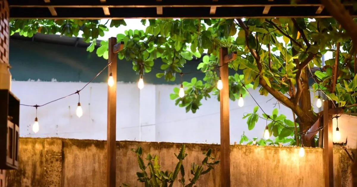 A backyard patio strung with warm lights at night