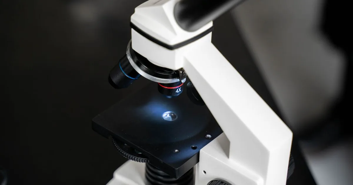 A laboratory microscope with a lit specimen stage