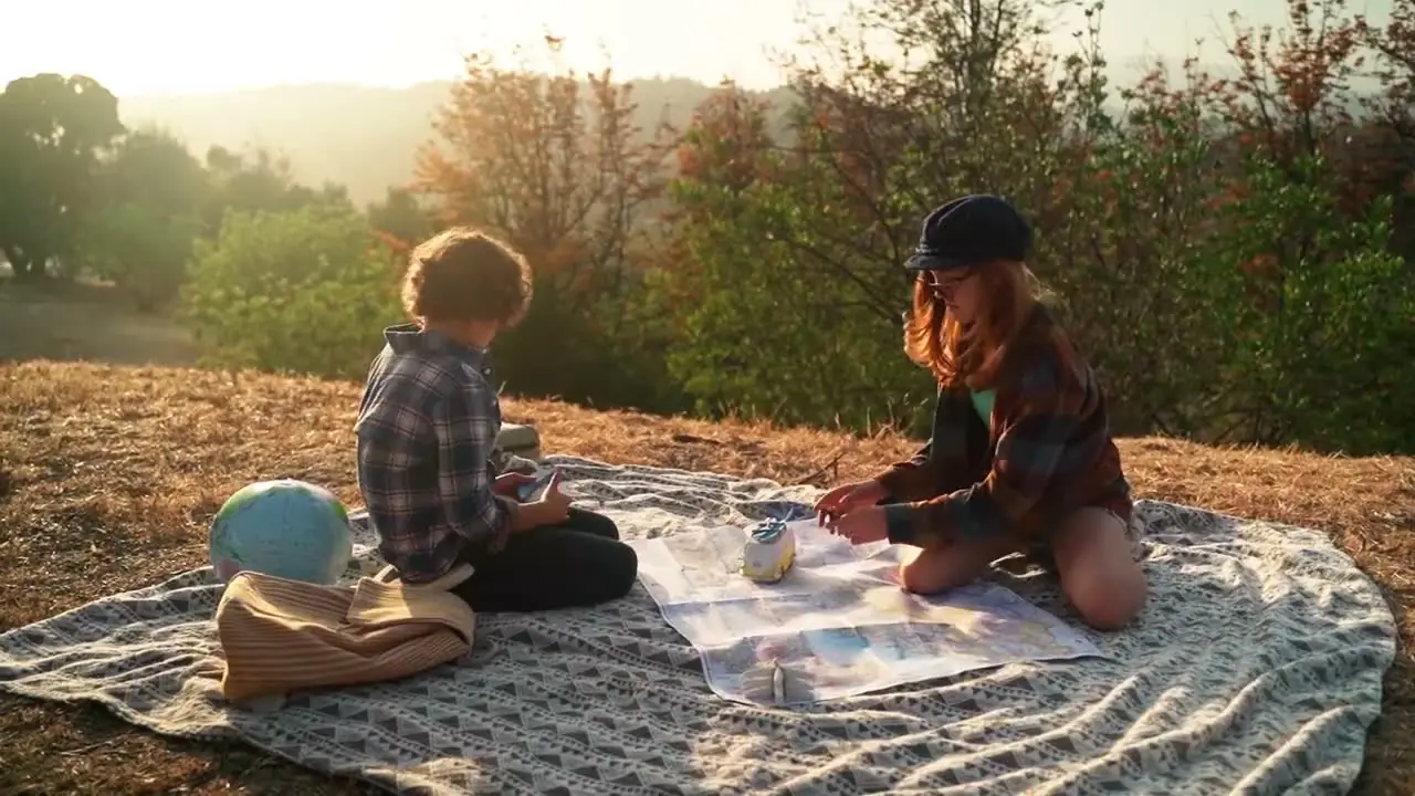 A picnic spread out on the grass in late-afternoon sun